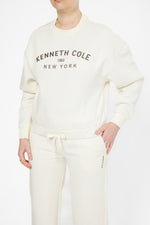 סווטשירט אוברסייז סיומת אלסטית בצבע שמנת