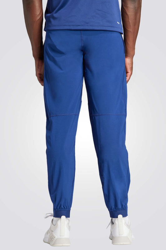 מכנסיים ארוכים לגברים TRAIN ESSENTIALS WOVEN בצבע כחול