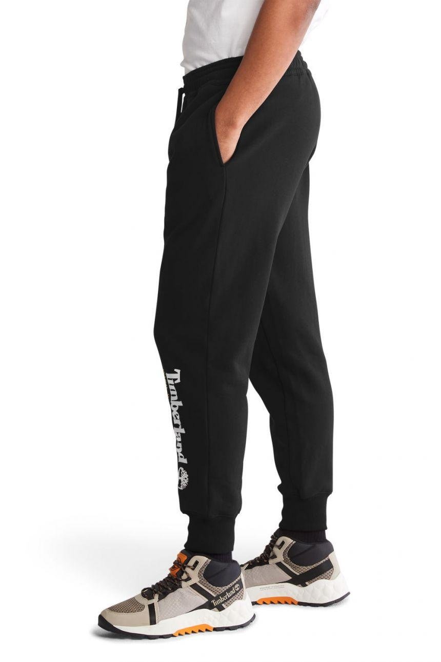 TIMBERLAND - מכנסי טרנינג עם הדפס לוגו המותג על הרגל בתחתית - MASHBIR//365