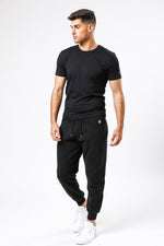 TIMBERLAND - מכנסי טרנינג עם לוגו המותג רקום בצד צבע שחור - MASHBIR//365